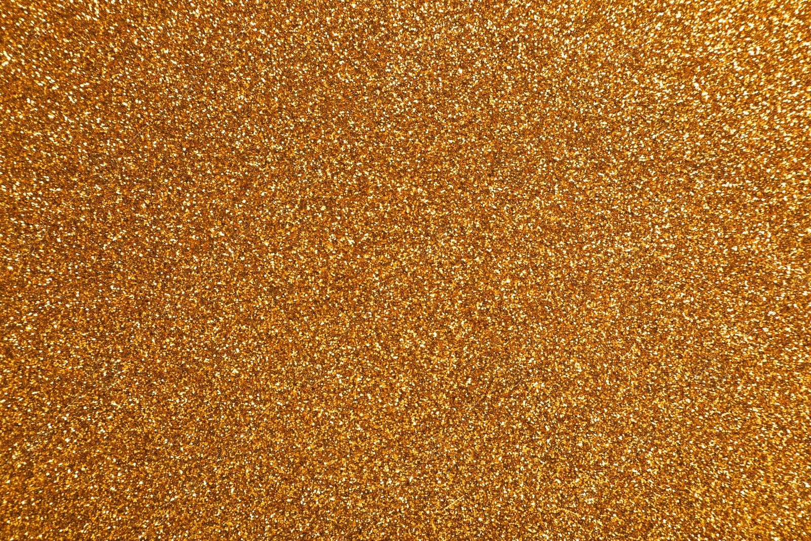 Photo of Beautiful shiny golden glitter as background, top view