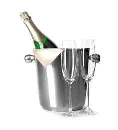 Photo of Empty glasses and metal bucket with bottle of champagne on white background