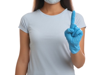 Photo of Woman in medical gloves with raised index finger on white background, closeup