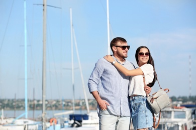 Young hipster couple in jean clothes on pier