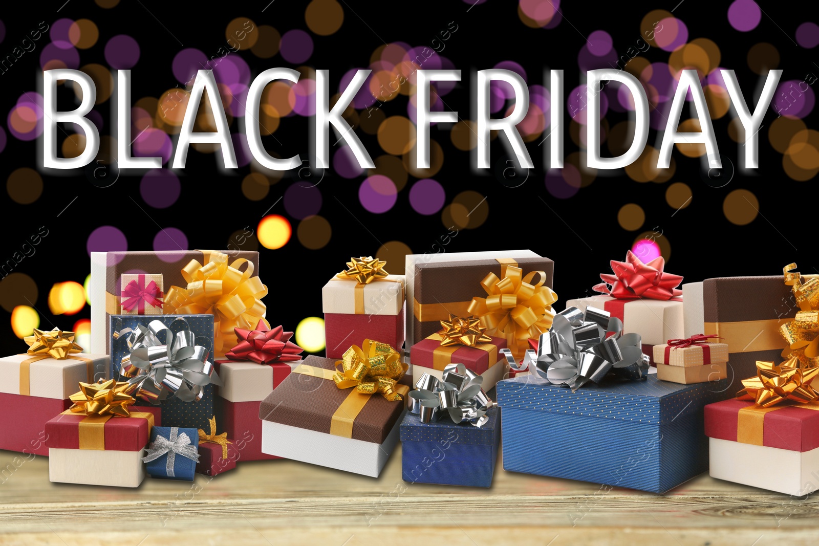 Image of Black Friday. Many gift boxes on wooden table against blurred lights 