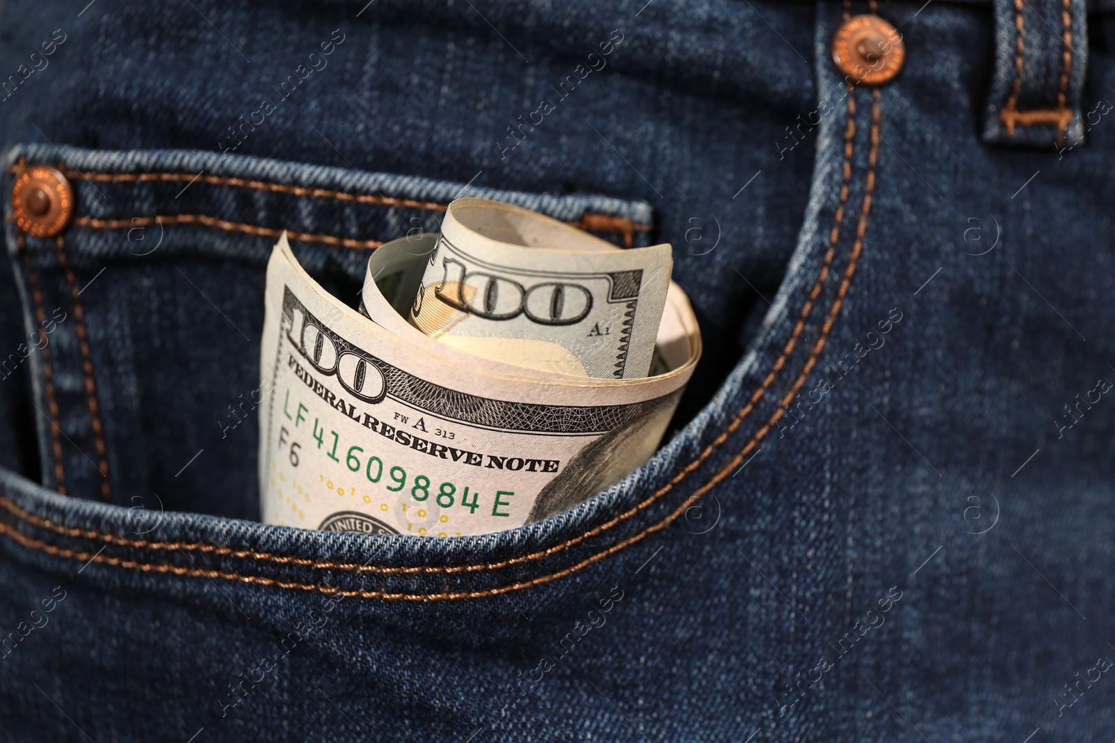 Photo of Dollar banknotes in pocket of jeans, closeup. Spending money