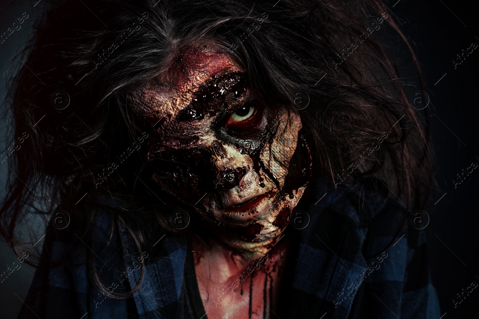 Photo of Scary zombie on dark background, closeup. Halloween monster