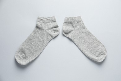Photo of Pair of socks on light grey background, flat lay