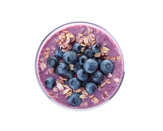 Photo of Glass of tasty blueberry smoothie with muesli on white background, top view