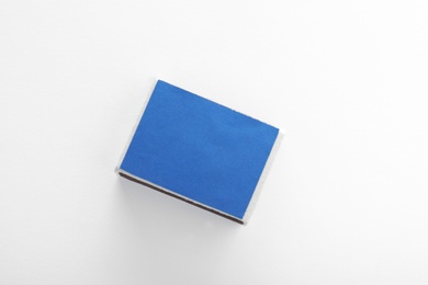 Photo of Closed matchbox on white background, top view. Space for design