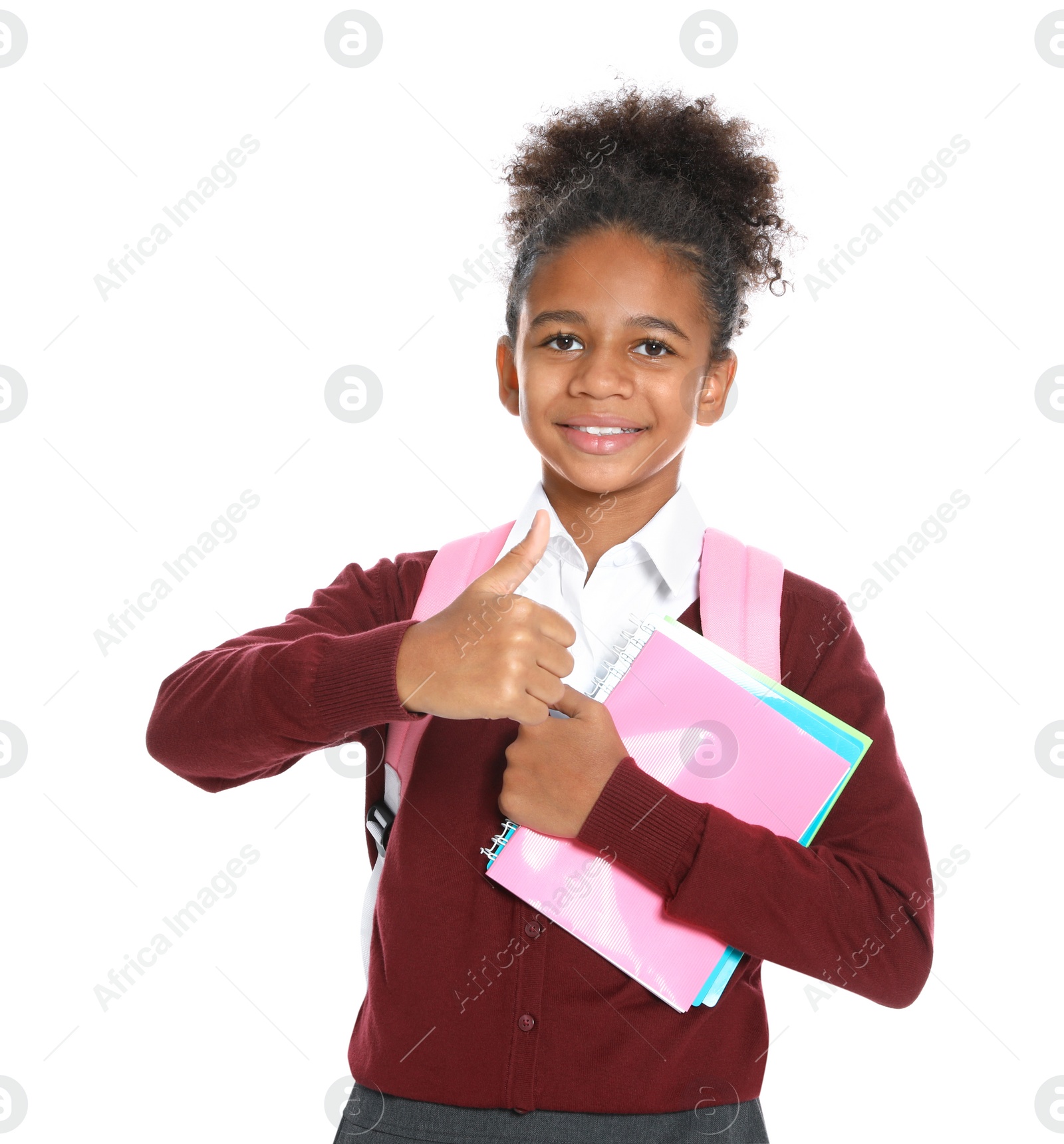 Photo of Happy African-American girl in school uniform on white background