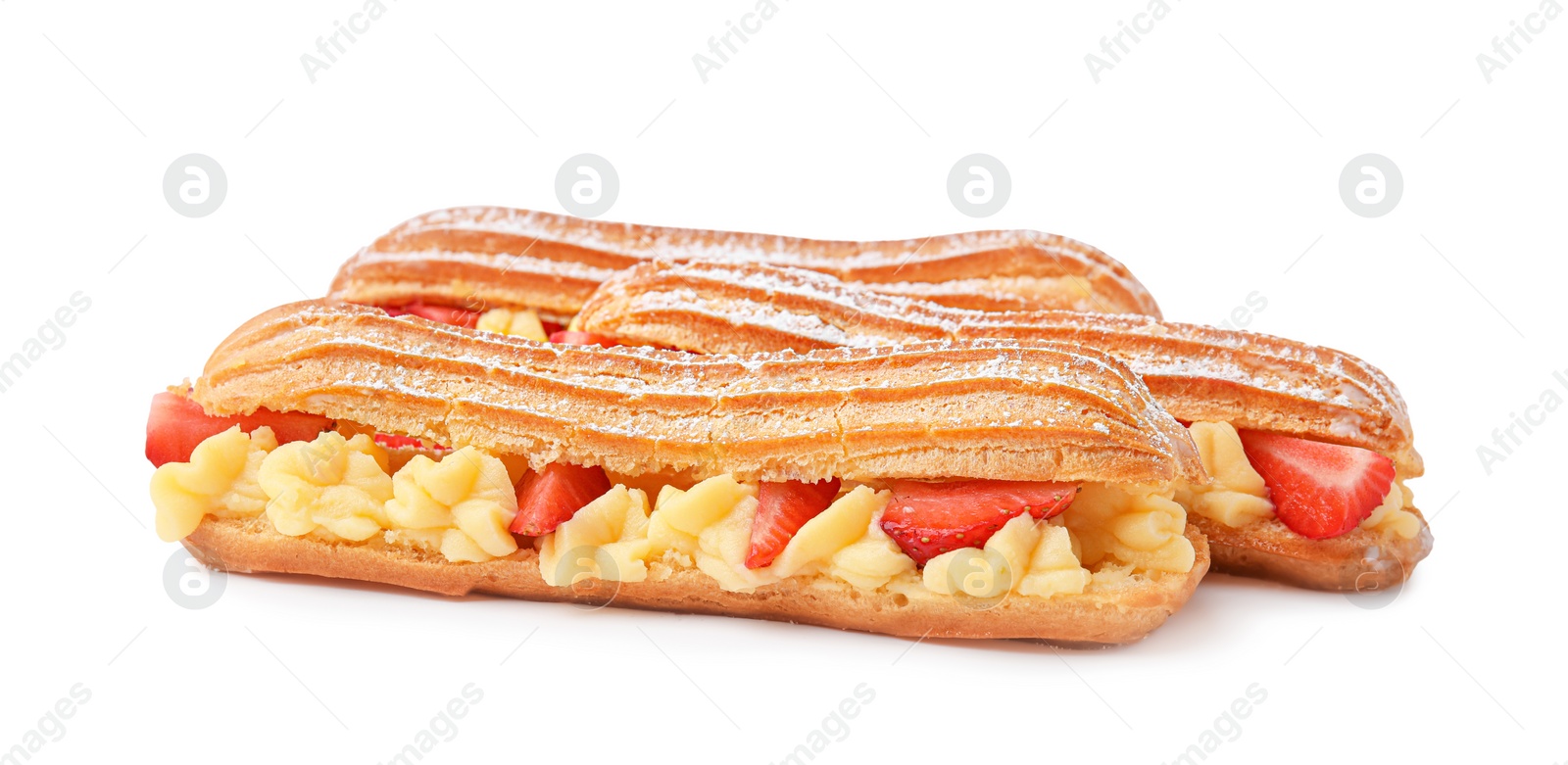 Photo of Delicious eclairs filled with cream and strawberries isolated on white