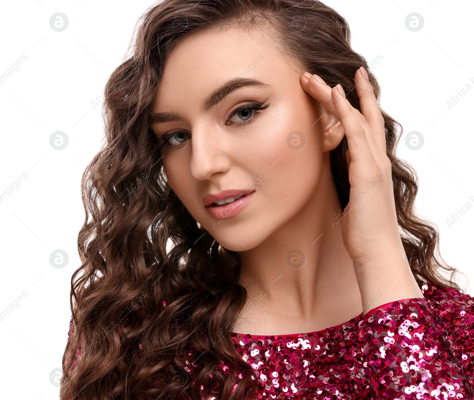 Photo of Beautiful young woman with long curly brown hair in pink sequin dress on white background