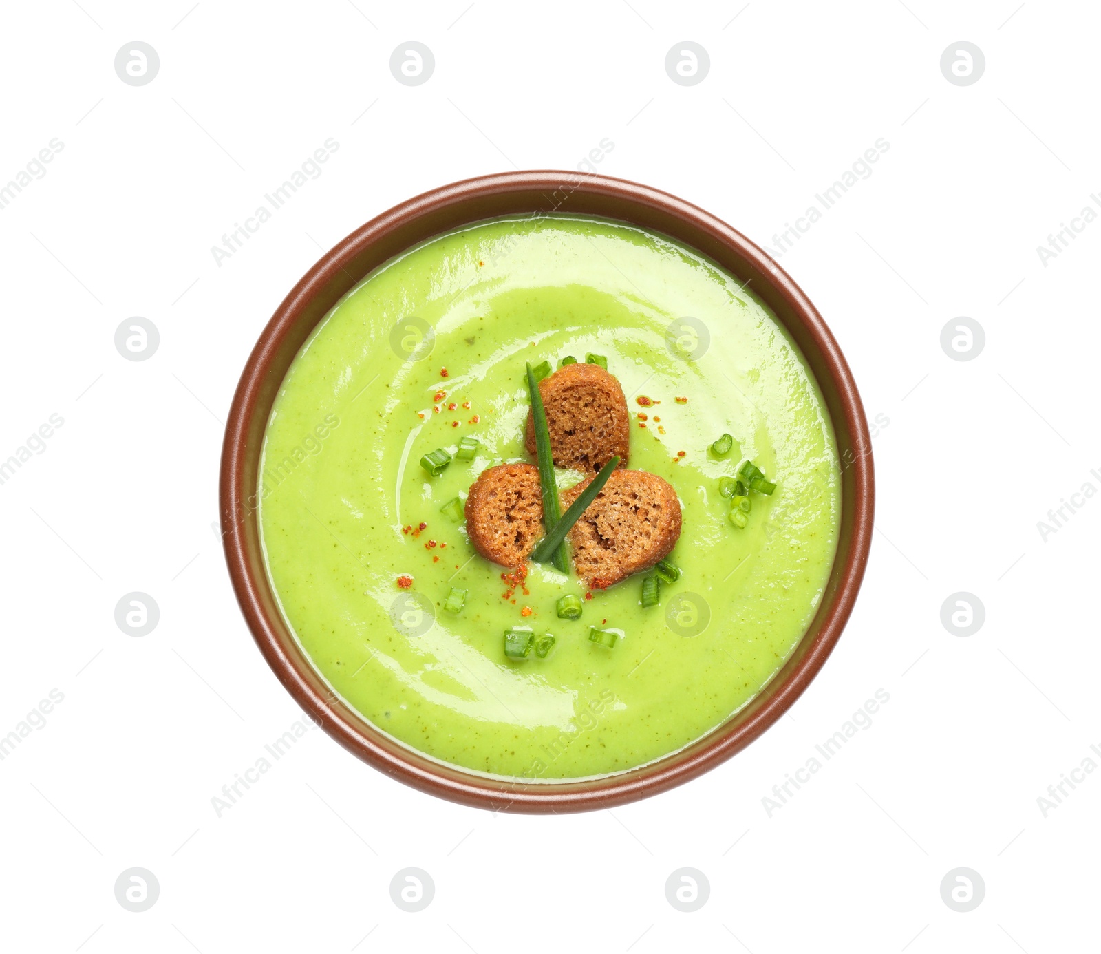 Photo of Tasty homemade zucchini cream soup isolated on white, top view