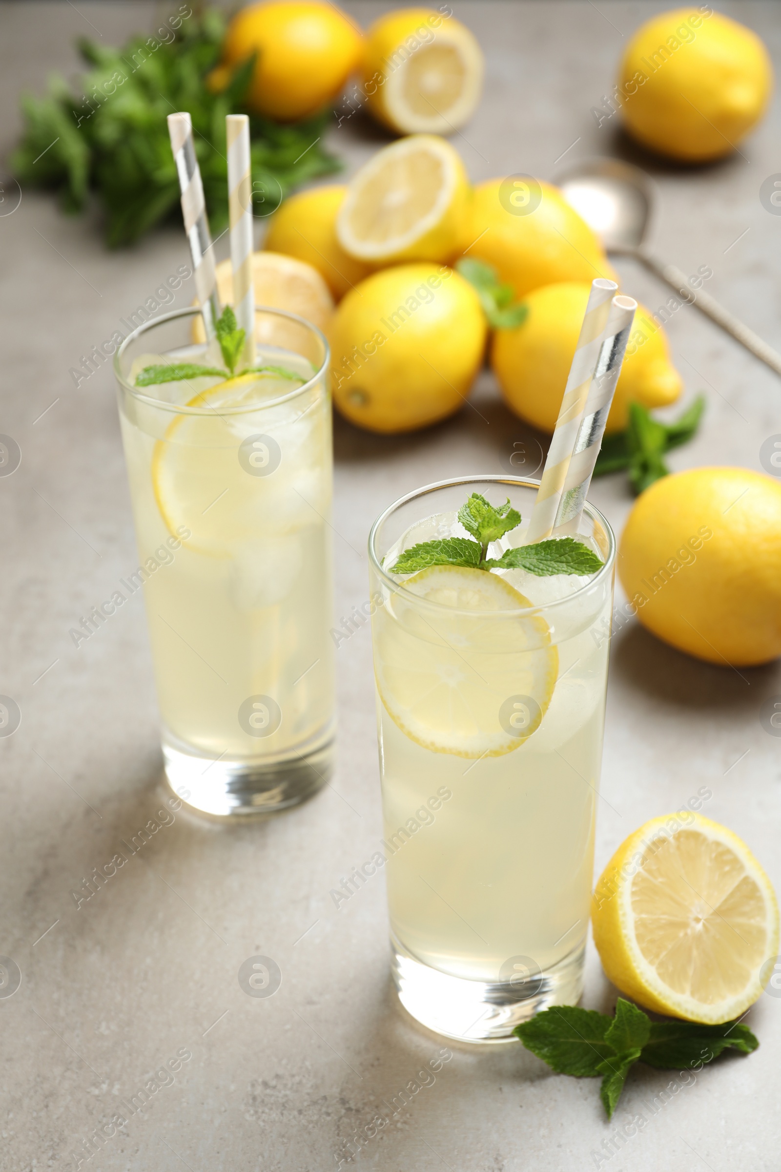 Photo of Natural lemonade with mint on light grey table. Summer refreshing drink