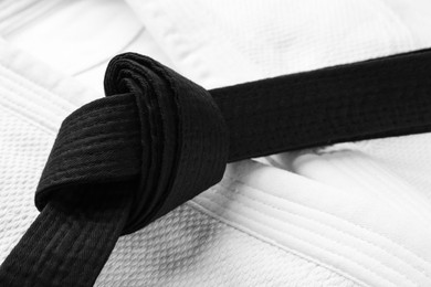 Photo of Martial arts uniform with black belt, closeup