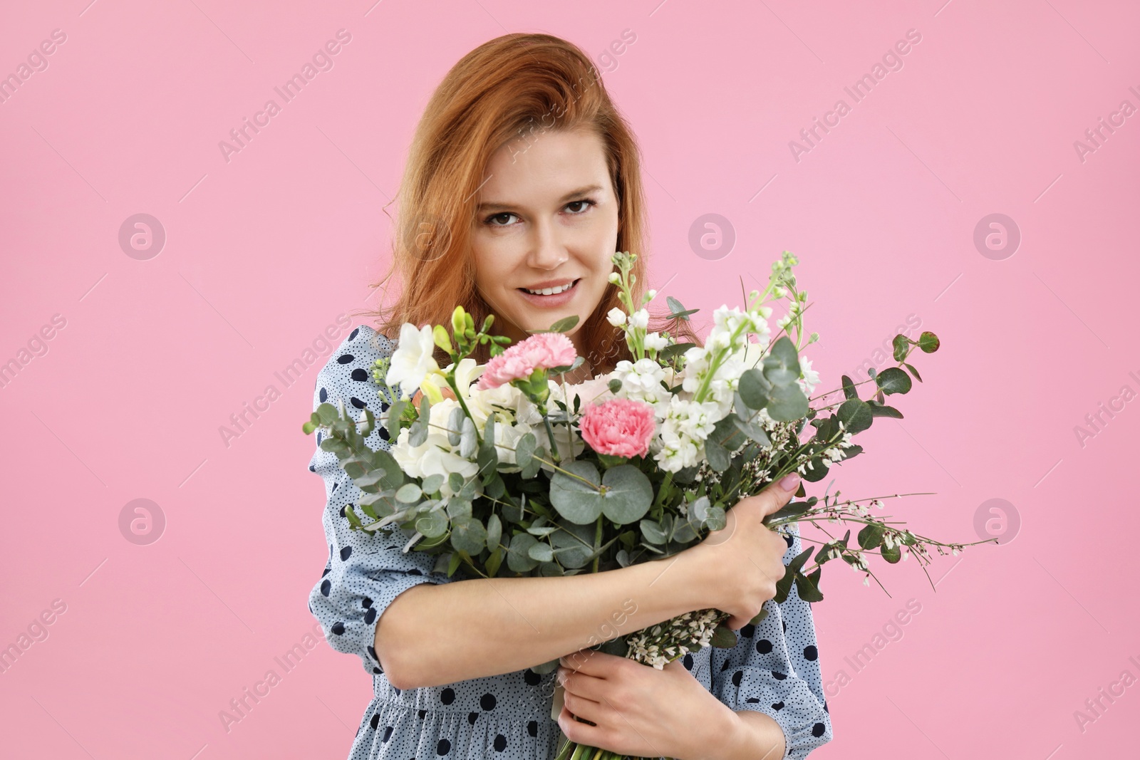 Photo of Beautiful woman with bouquet of flowers on pink background