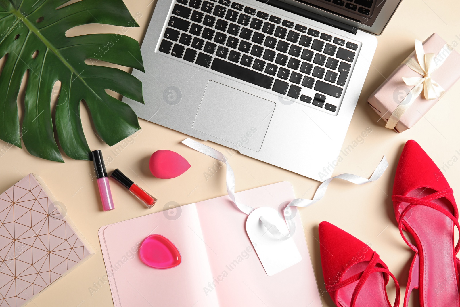 Photo of Flat lay composition with laptop and cosmetics on color background. Beauty blogger's workplace