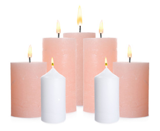 Image of Set of burning color candles on white background