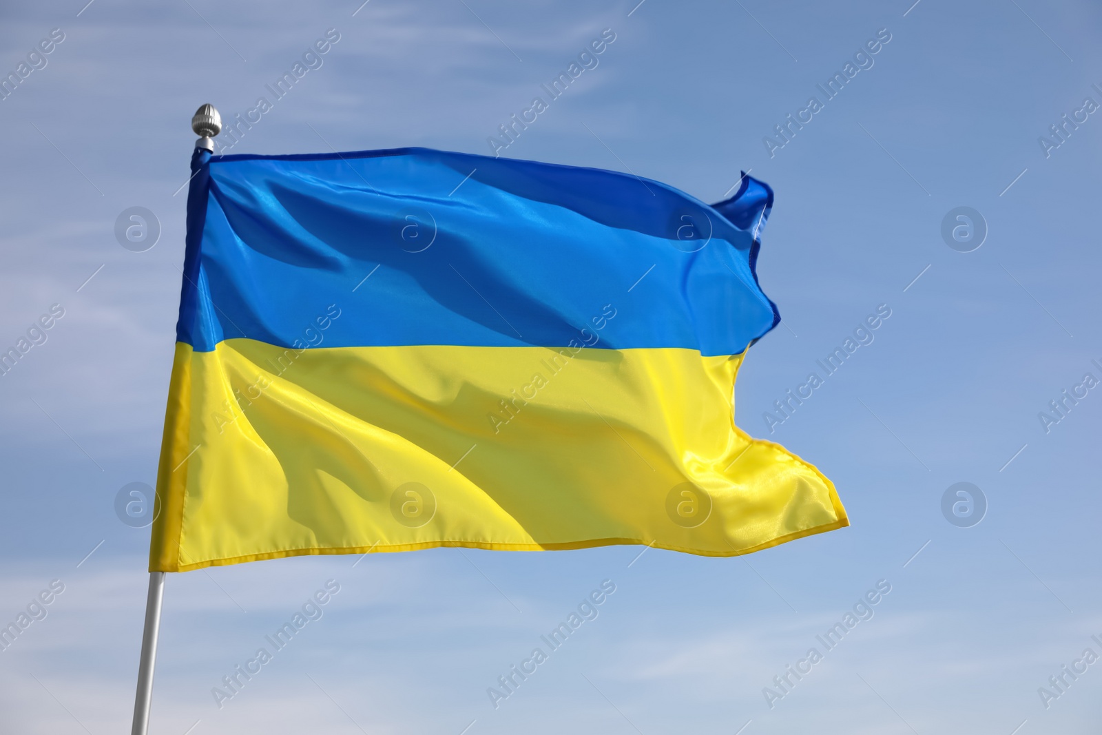 Photo of National flag of Ukraine against blue sky, closeup