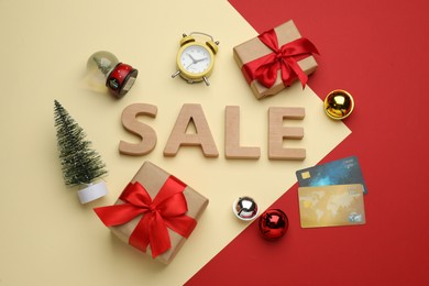 Flat lay composition with word Sale on color background