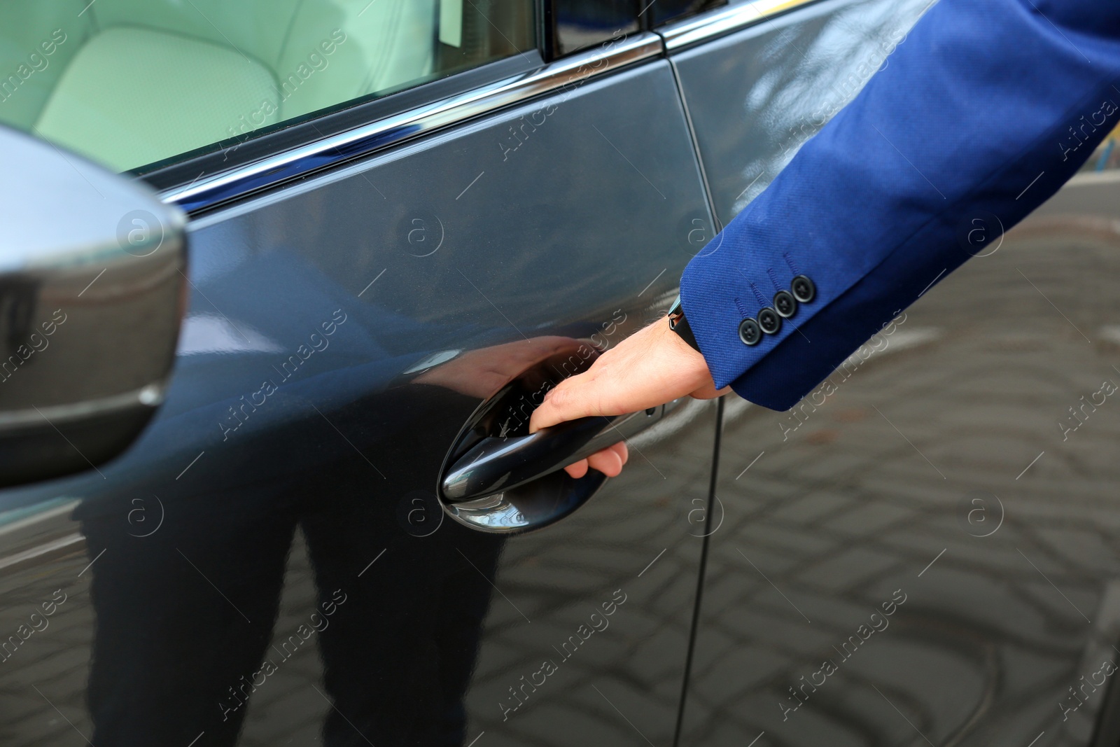 Photo of Closeup view of man opening car door