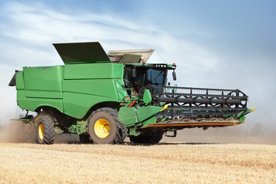 Modern combine harvester working in agricultural field