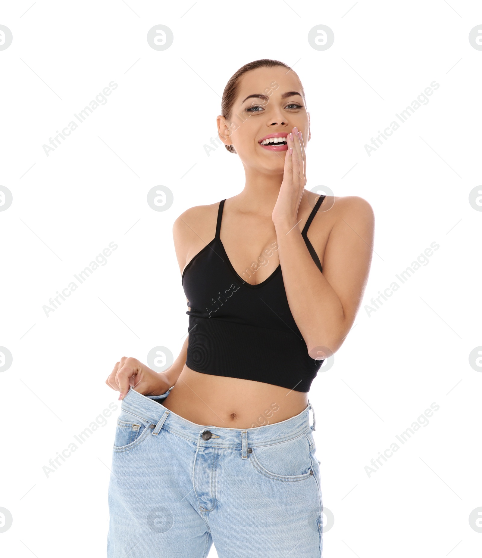 Photo of Slim woman in oversized jeans on white background. Weight loss