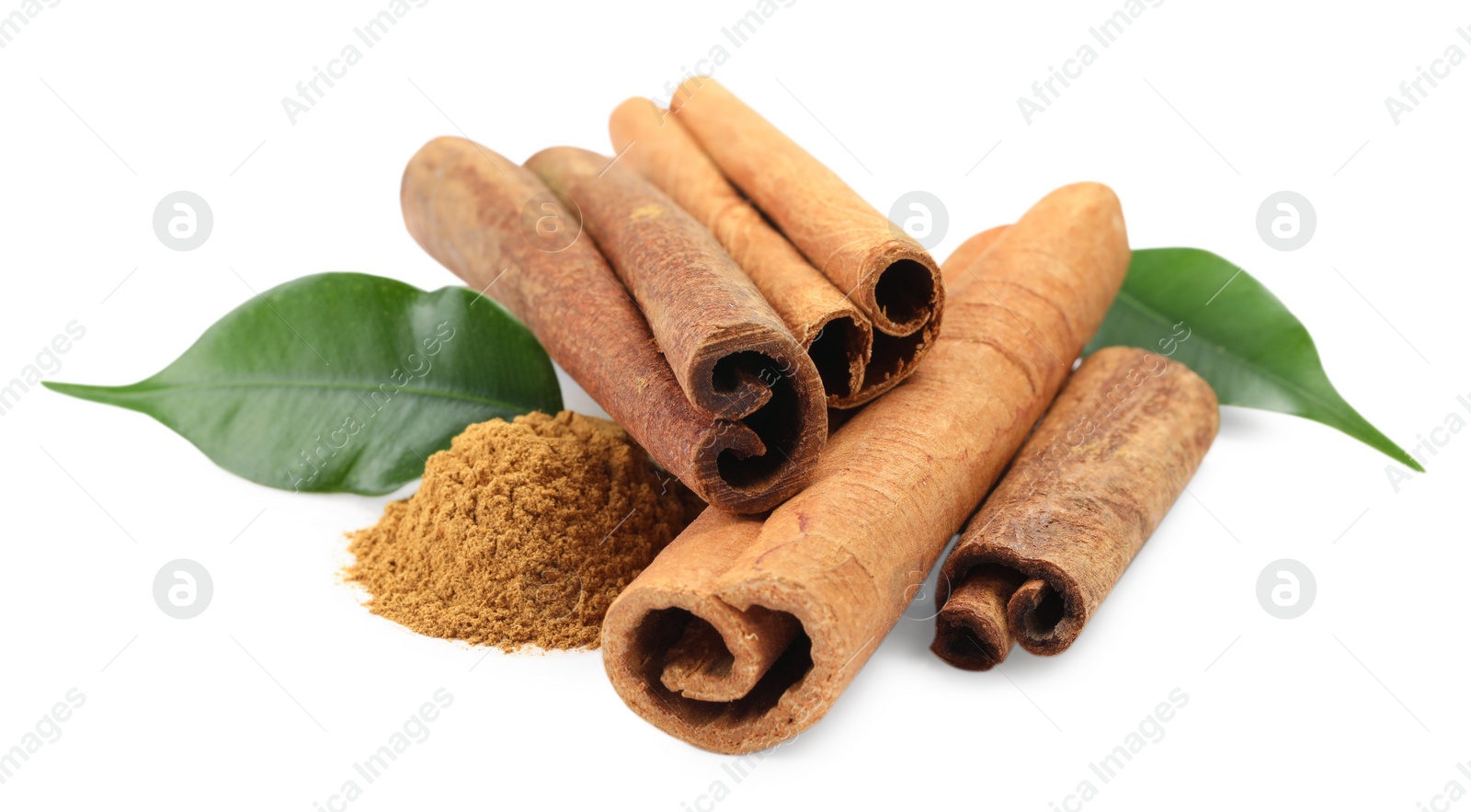 Photo of Dry aromatic cinnamon sticks, powder and green leaves isolated on white