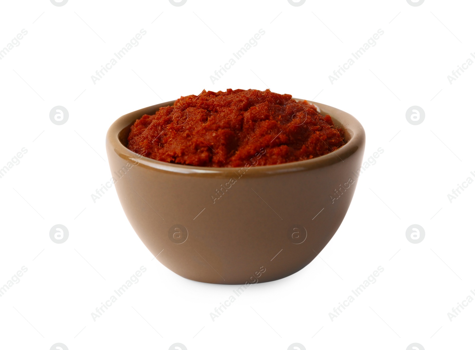 Photo of Tasty curry paste in bowl isolated on white