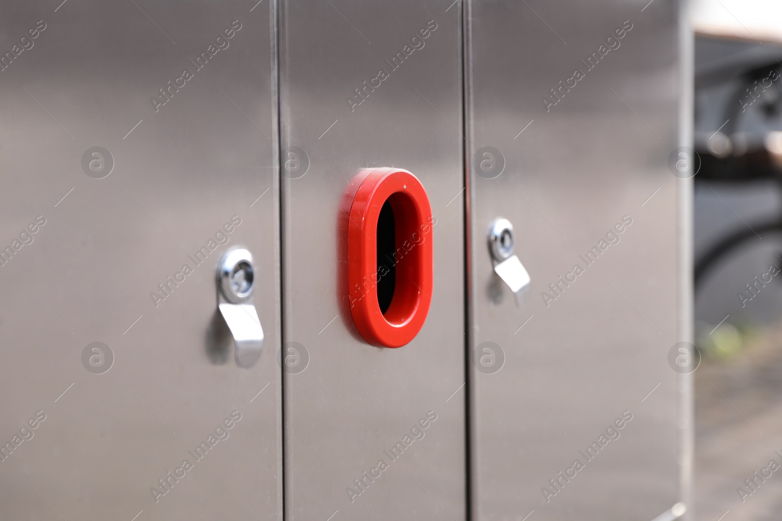 Photo of Modern metal recycling bin outdoors, closeup view