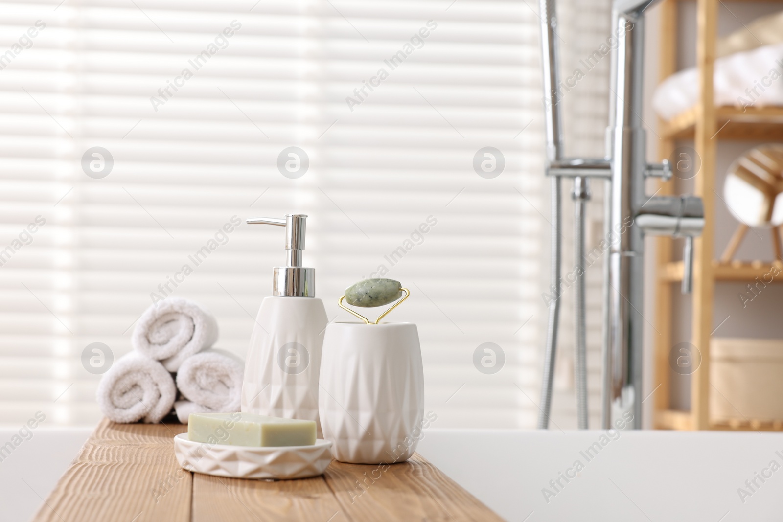 Photo of Different personal care products on bath tub in bathroom