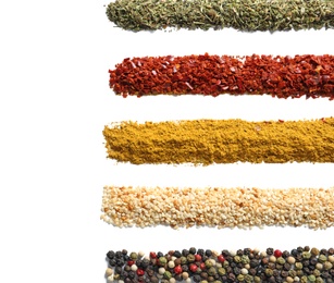 Photo of Rows of different aromatic spices on white background, top view with space for text