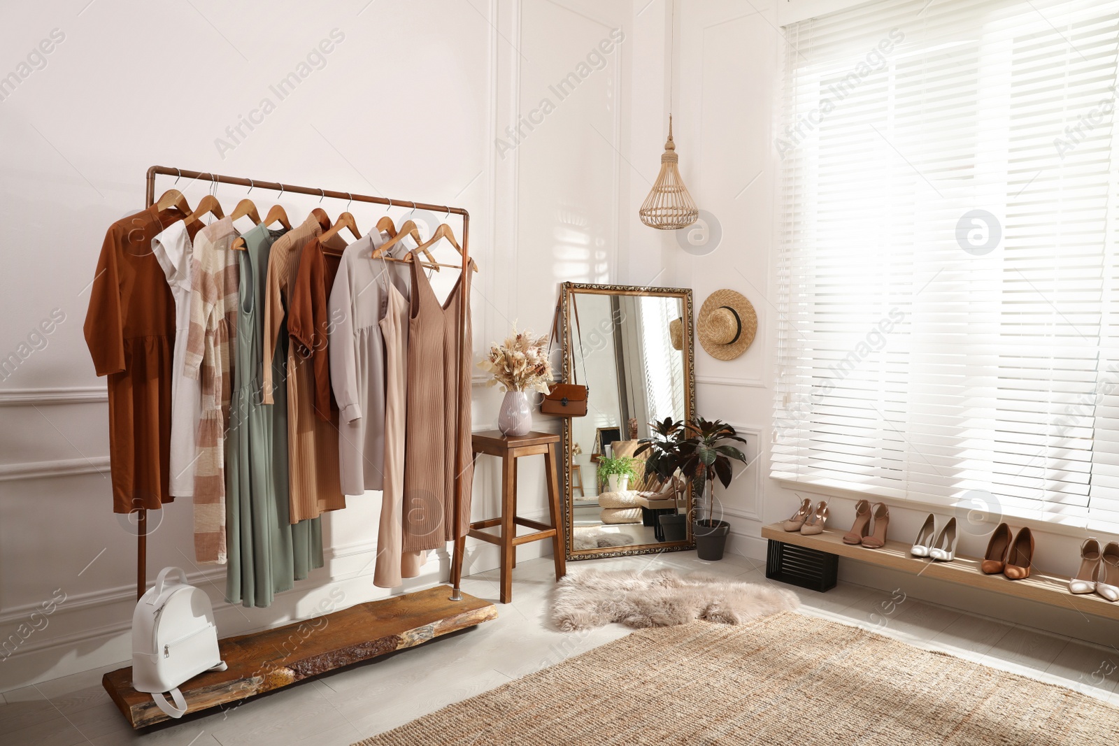 Photo of Dressing room interior with stylish clothes, shoes and accessories