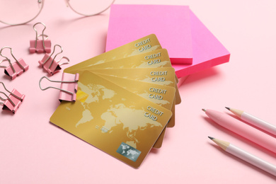 Photo of Credit cards and stationery on pink background