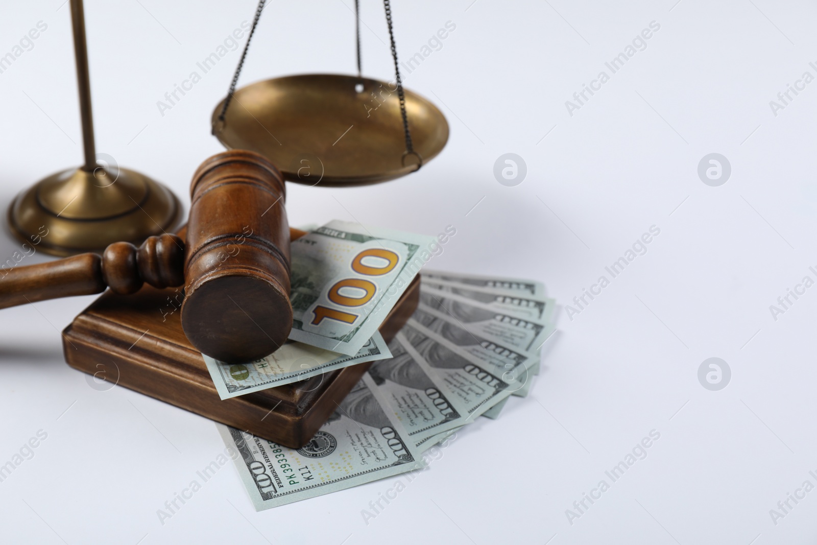 Photo of Judge's gavel, scales of justice and money on white background, closeup. Space for text