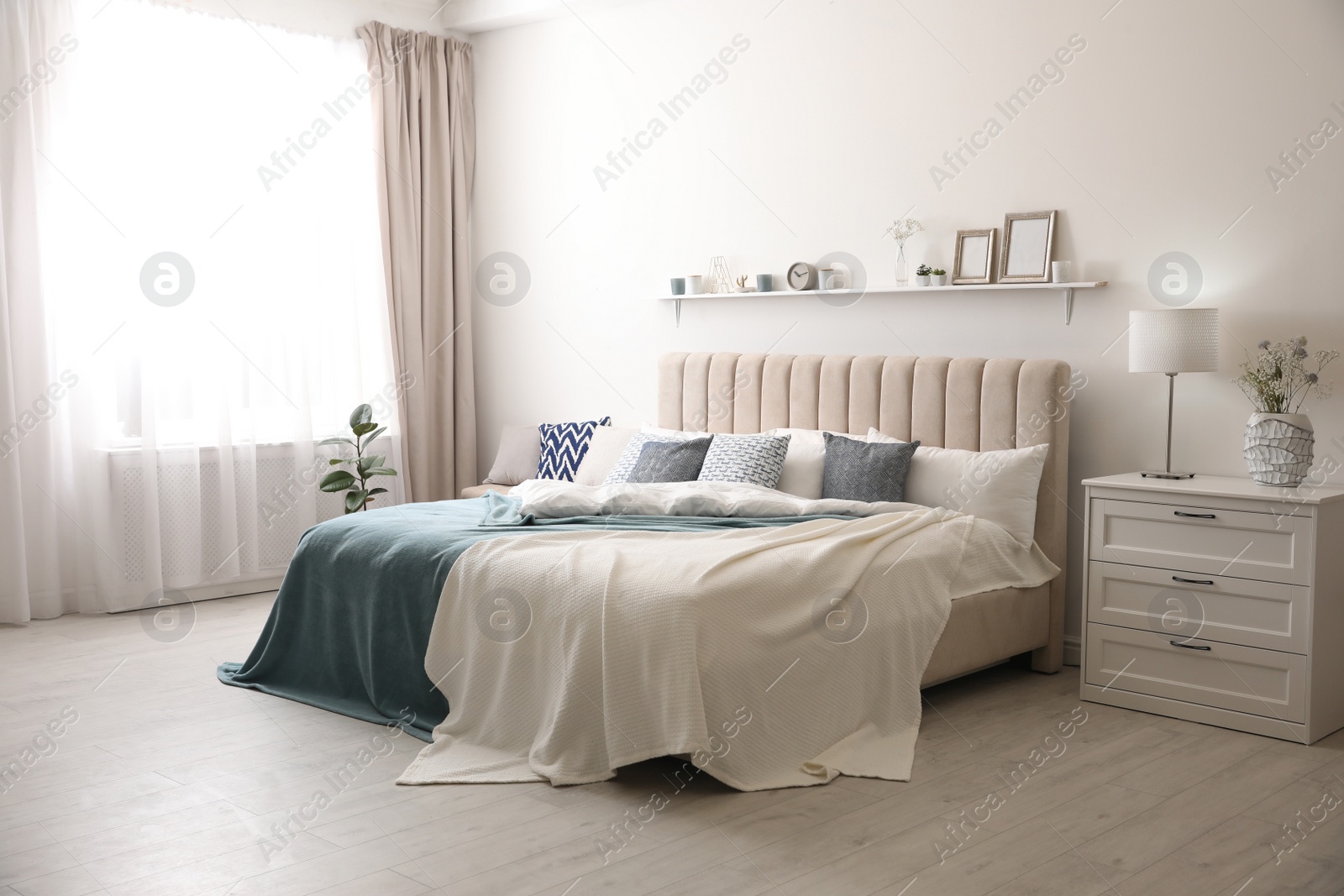 Photo of Comfortable bed with pillows in room. Stylish interior design