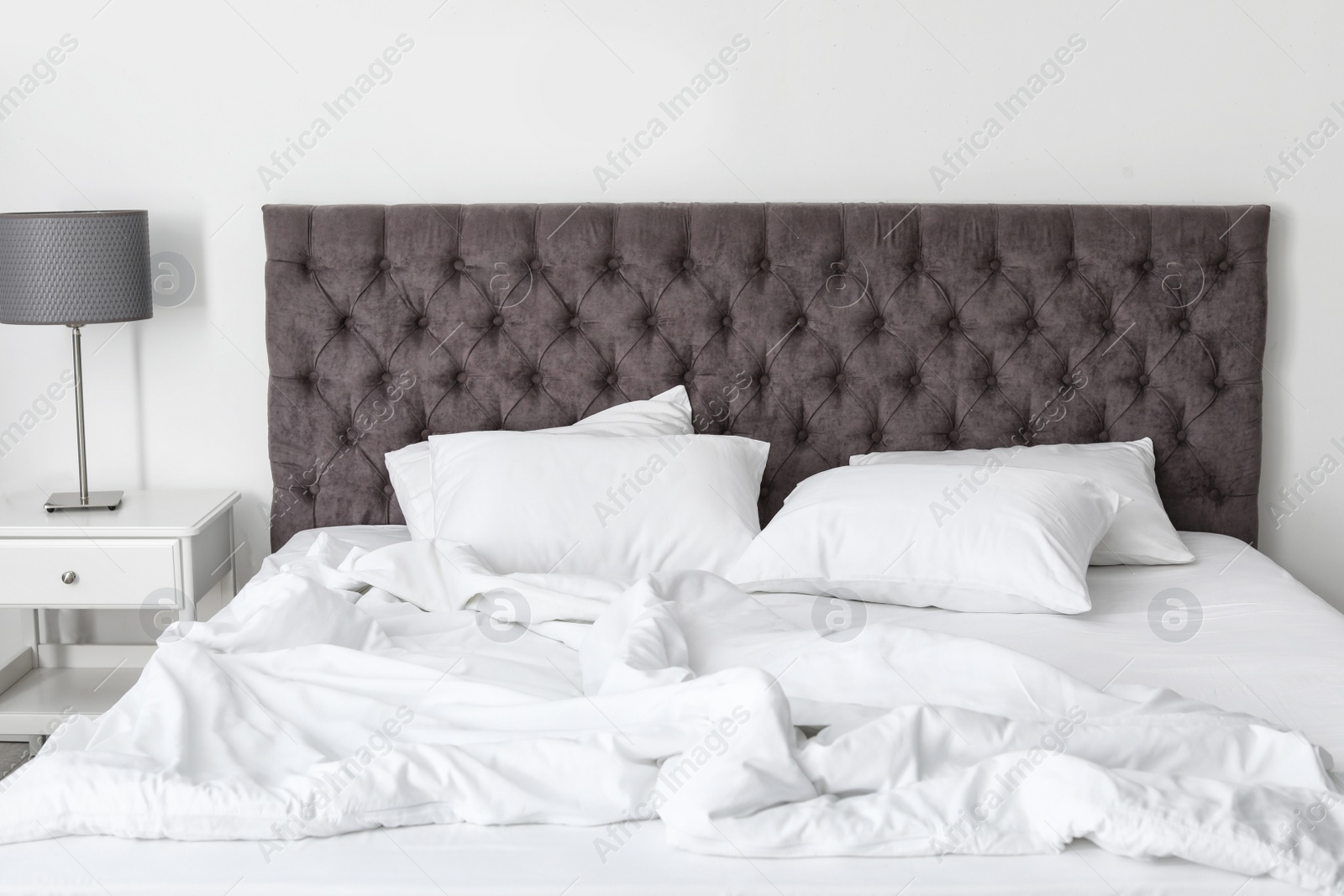 Photo of Soft white pillows on comfortable bed indoors