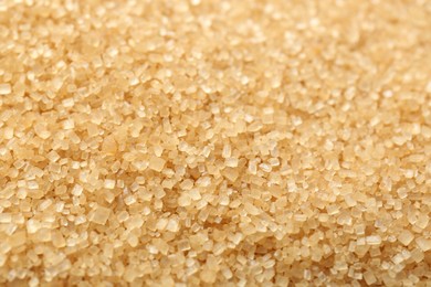 Photo of Granulated brown sugar as background, closeup view