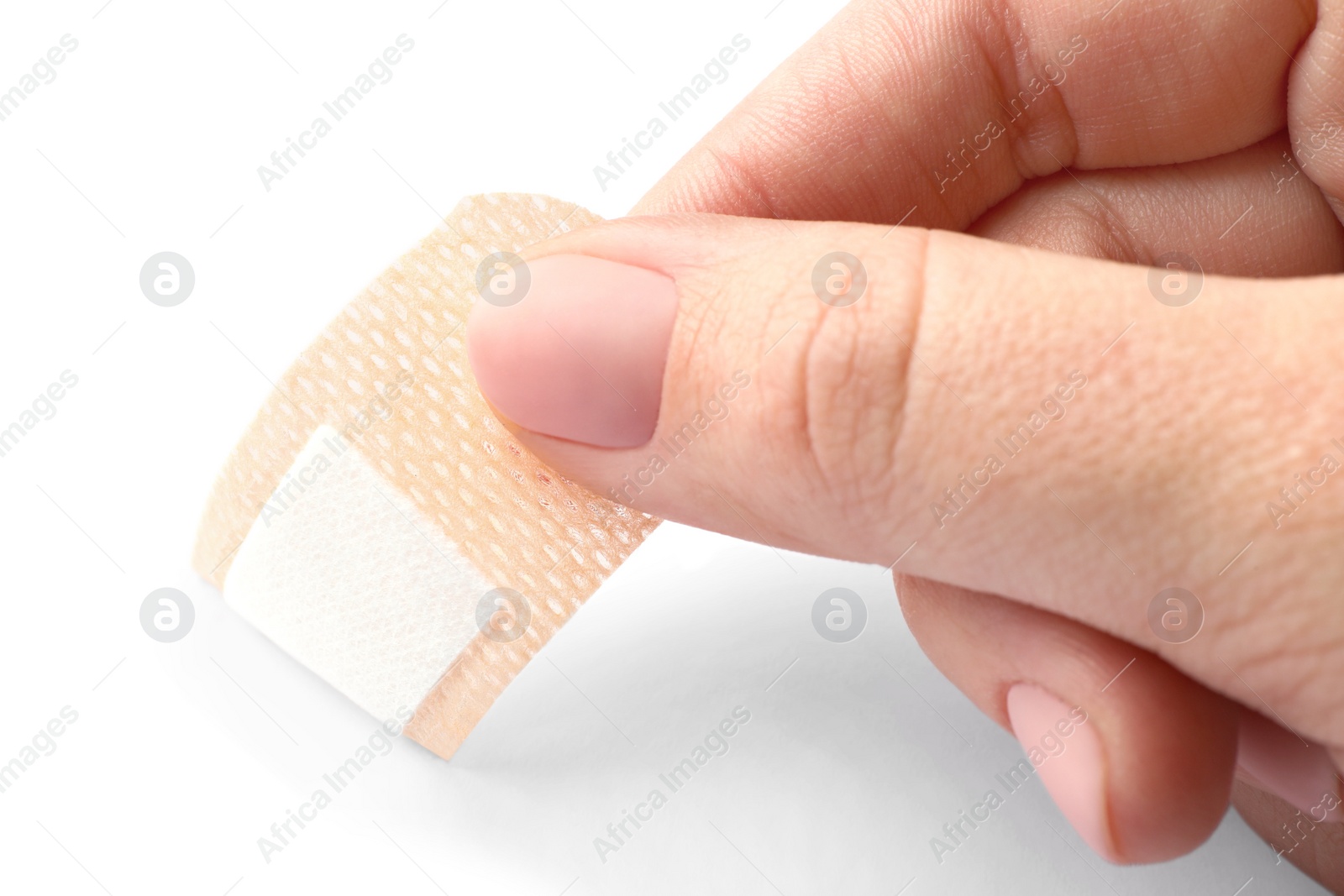 Woman putting sticking plaster on white background, closeup. First aid item Photo of Woman putting sticking plaster on white background, closeup. First aid item