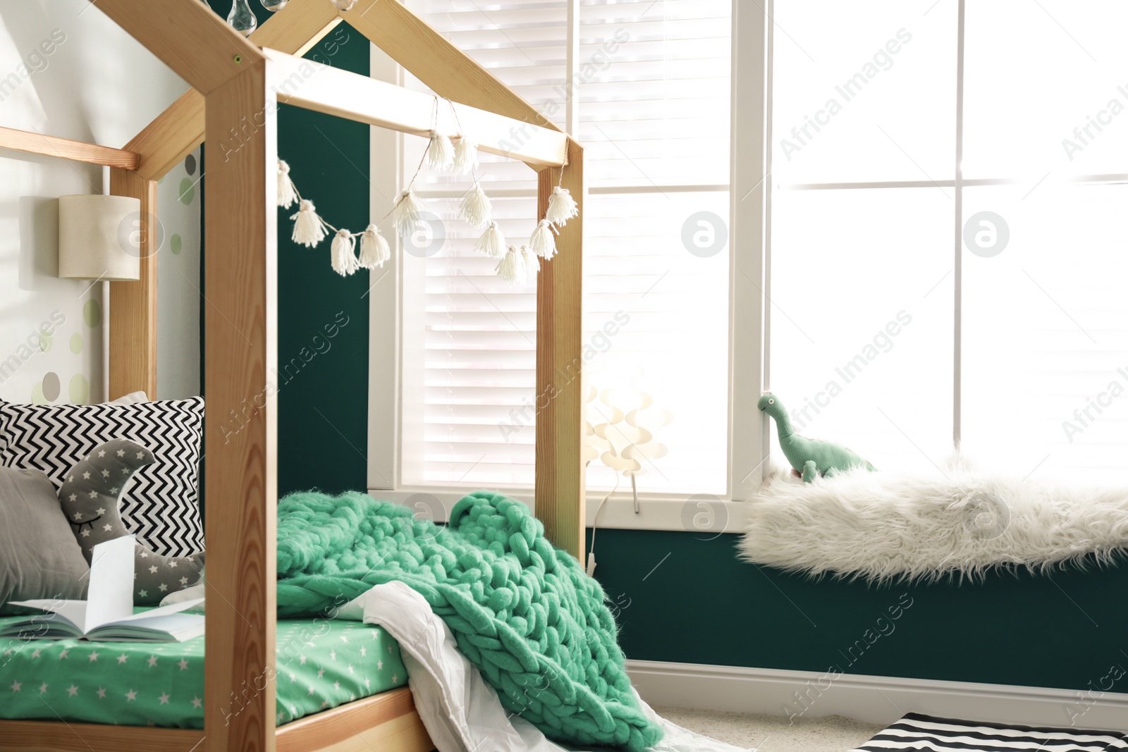 Photo of Cozy child room interior with comfortable bed