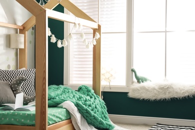 Photo of Cozy child room interior with comfortable bed