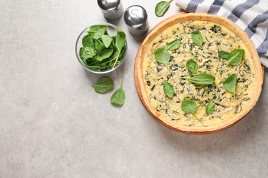 Delicious homemade spinach pie on light grey table, flat lay. Space for text