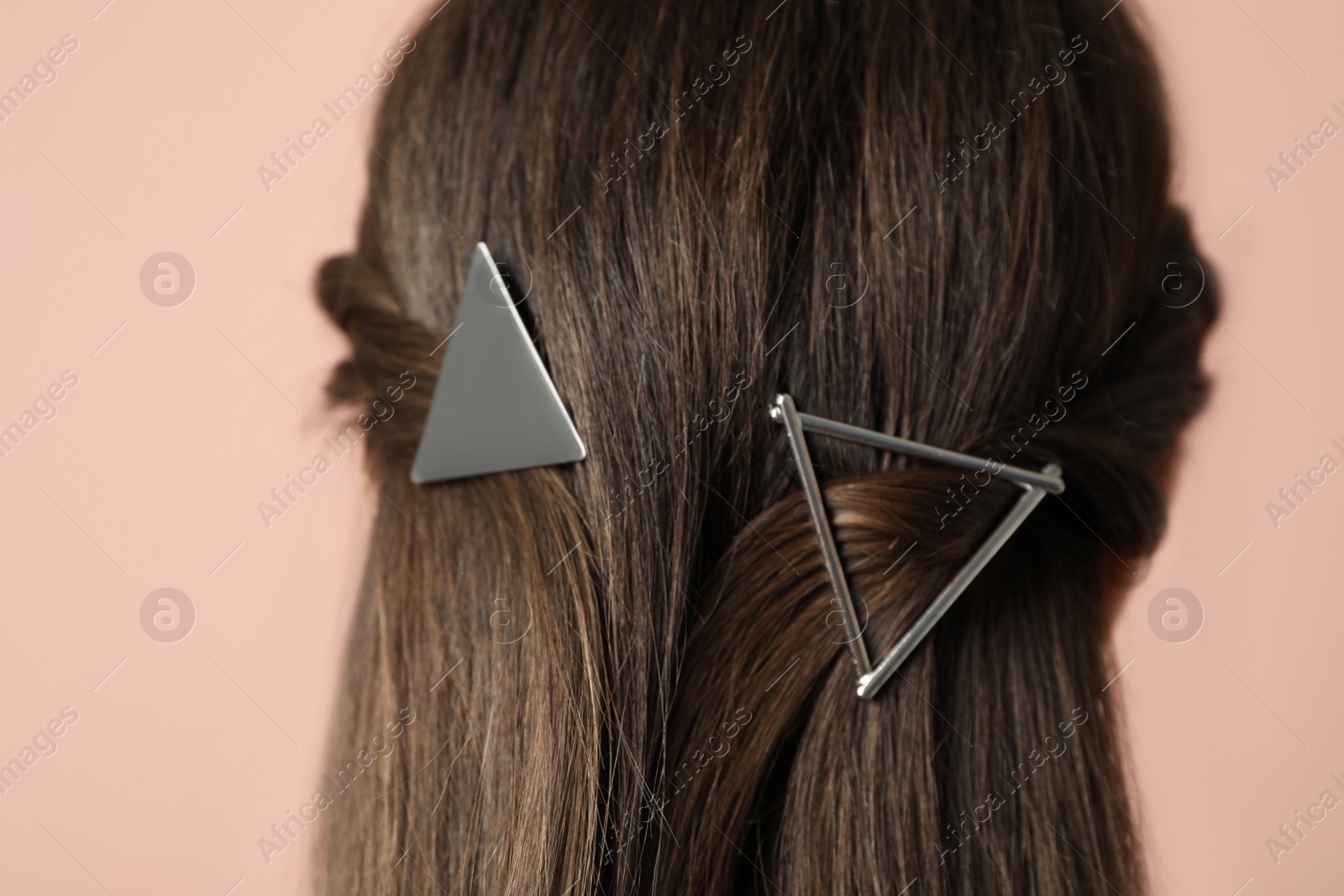 Photo of Woman with beautiful hair clips on pink background, closeup