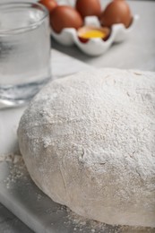 Photo of Dough on white marble board, closeup. Sodawater bread recipe