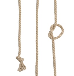 Photo of Strong cotton ropes with knots on white background