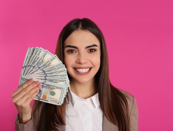 Photo of Young businesswoman with money on color background