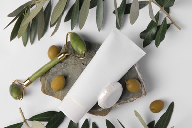 Flat lay composition with different cosmetic products and olives on white background