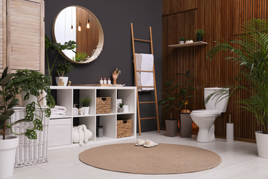 Elegant interior of modern bathroom with green plants