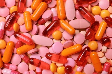 Many different pills as background, top view