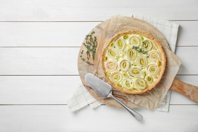 Photo of Tasty leek pie on white wooden table, top view. Space for text