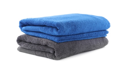 Photo of Folded soft terry towels isolated on white