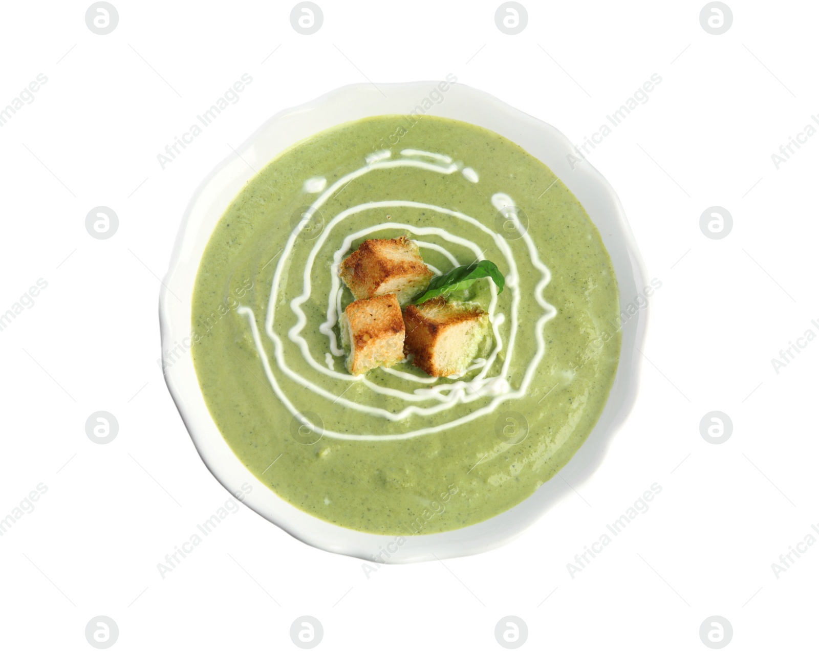 Photo of Delicious broccoli cream soup with croutons isolated on white, top view