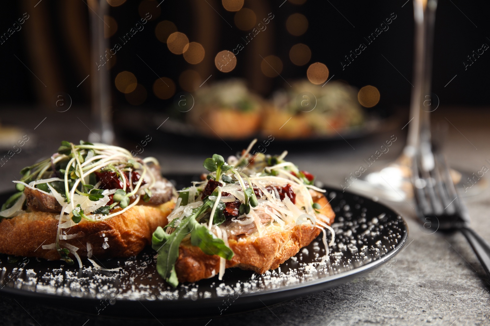 Photo of Delicious bruschettas with beef and cheese on grey table, closeup